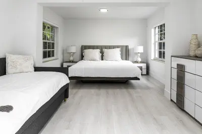a white bedroom with two beds and two windows at Harbor Beach in Fort Lauderdale