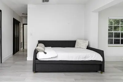 a bed in a room with a white wall at Harbor Beach in Fort Lauderdale