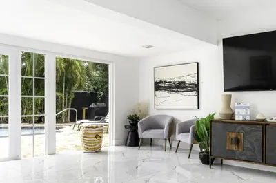 a living room with white walls and a tv at Harbor Beach in Fort Lauderdale