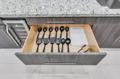 a drawer with black utensils in a kitchen at Supremacy Villa STR-6110 in Davie