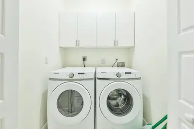 a white laundry room with two washer and dryer at Supremacy Villa STR-6110 in Davie