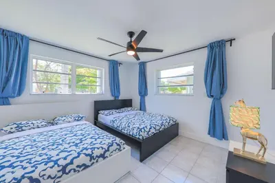 a bedroom with two beds and a ceiling fan at Eat Pray Love Villa in Hollywood