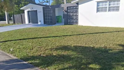 a house with a large lawn in front of it at Sunrise Oasis in Sunrise