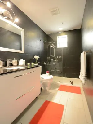 a bathroom with a sink and a toilet and a tub at Art Deco Ocean Drive Suites in Miami Beach