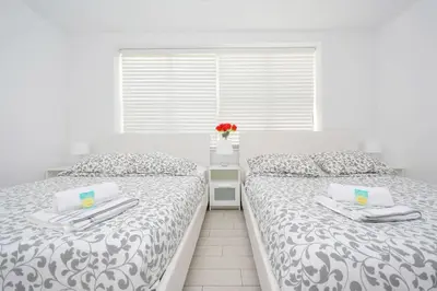 two beds sitting next to each other in a bedroom at Art Deco Ocean Drive Suites in Miami Beach