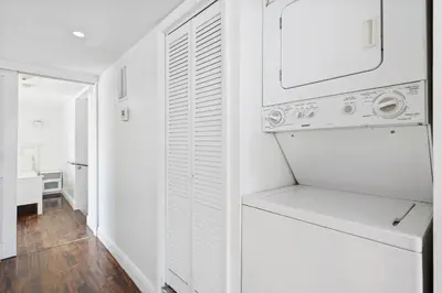 a white kitchen with a washer and dryer at Art Deco Ocean Drive Suites in Miami Beach