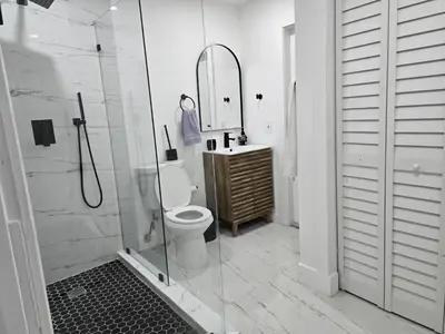 a bathroom with a shower and a toilet and a sink at Sunrise Oasis in Sunrise