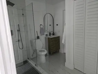 a bathroom with a shower and a toilet and a sink at Sunrise Oasis in Sunrise