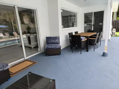 a patio with a table and chairs on a house at Sunrise Oasis in Sunrise