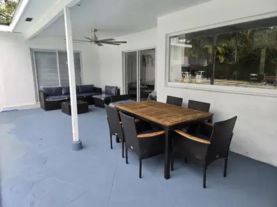 a wooden table and chairs in a living room at Sunrise Oasis in Sunrise