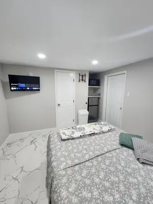 a bedroom with a large bed and a tv on the wall at Amazing room in Hollywood in Carver Ranches
