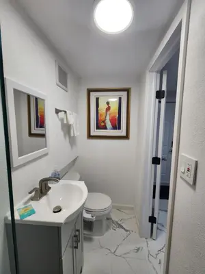 a white bathroom with a sink and a toilet at Amazing room in Hollywood in Carver Ranches