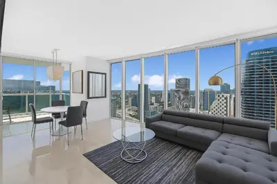 a living room with a couch and a table at Icon Brickell Penthouse Panoramic Skyline by IliosRentals in Miami