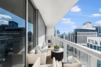 a balcony with white furniture and a view of the city at Icon Brickell Penthouse Panoramic Skyline by IliosRentals in Miami