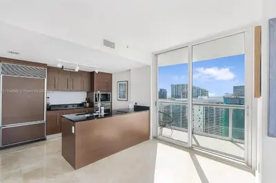 a kitchen with a view of a city skyline at Icon Brickell Penthouse Panoramic Skyline by IliosRentals in Miami