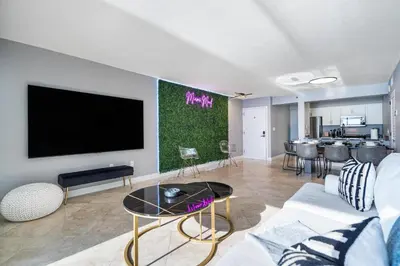 a living room with a couch and a tv at Brickell Ocean View Condo with Free Parking in Miami