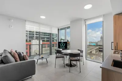 a living room with a couch and a table and chairs at Premium High-Rise Living at 501 First - Downtown Miami in Miami