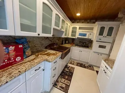 a kitchen with white cabinets and a sink at C16P Oceanfront Penthouse in Hollywood FL in Hollywood