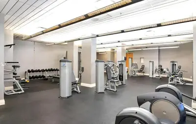 a gym with treadmills and machines in a room at C16P Oceanfront Penthouse in Hollywood FL in Hollywood