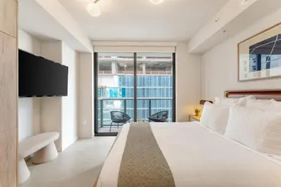 a bedroom with a large bed and a large window at Crosby Miami WTC Studio Sleek #2506 in Miami