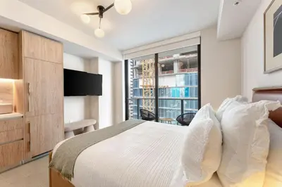 a bedroom with a bed and a large window at Crosby Miami WTC Studio Sleek #2506 in Miami