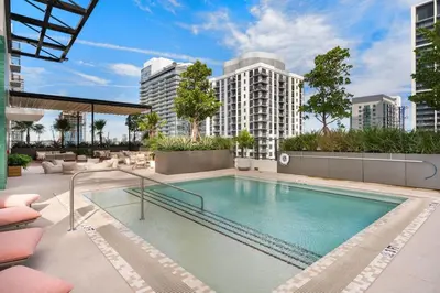 a swimming pool on a building with tall buildings at Crosby Miami WTC Studio Sleek #2506 in Miami