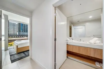 a bathroom with a tub and a bed and a window at Crosby Miami WTC 2BR 2BA Corner City Residence #601 in Miami