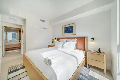 a white bedroom with a large bed and a bathroom at Crosby Miami WTC 2BR 2BA Corner City Residence #601 in Miami