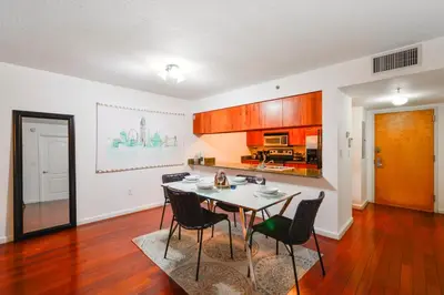 a kitchen and dining room with a table and chairs at Brickell Stay with City Views in Miami