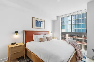 a bedroom with a bed and a window at Central Downtown Condo with Pool and Gym in Miami