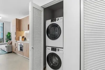 a laundry room with two washer and dryer machines at Central Downtown Condo with Pool and Gym in Miami