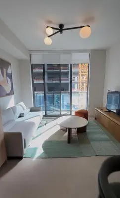 a living room with a couch and a table at The Crosby Miami World Center in Miami
