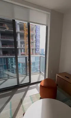 a room with a table and a large window at The Crosby Miami World Center in Miami