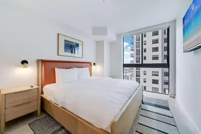 a bedroom with a bed and a large window at Sky Sanctuary with Rooftop Pool & Hot tub in Miami