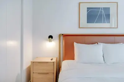 a hotel room with a bed and a night stand at Sky Sanctuary with Rooftop Pool & Hot tub in Miami