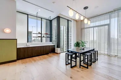 a dining room with a table and some windows at Sky Sanctuary with Rooftop Pool & Hot tub in Miami
