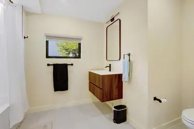 a bathroom with a sink and a mirror at Hollywood Palms: Mins to beach, Pool, Spa, BBQ in Hollywood