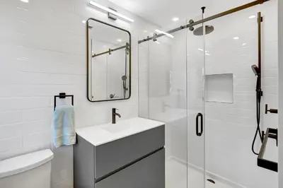 a white bathroom with a sink and a mirror at Hollywood Palms: Mins to beach, Pool, Spa, BBQ in Hollywood