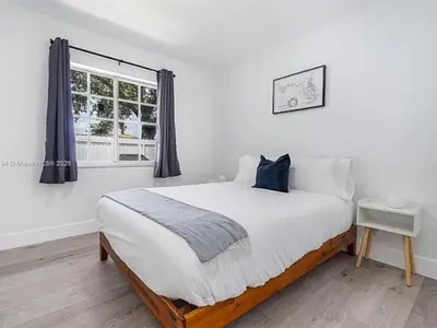 a white bedroom with a large bed and a window at Large 4 bedroom Midtown Great Area in Miami