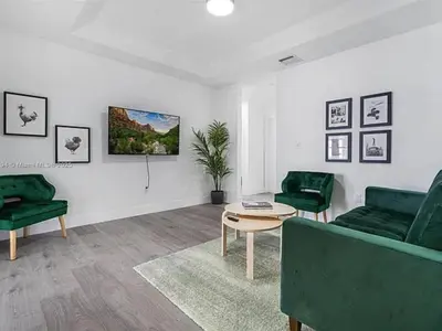 a living room with two green couches and a table at Large 4 bedroom Midtown Great Area in Miami