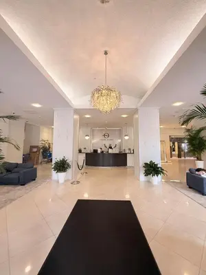 a lobby with a chandelier and a living room at Modern 2BR beachfront with pool & tennis view in Sunny Isles Beach