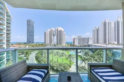 a balcony with two chairs and a view of the ocean at Introdused by Ocean Reserve free parking STR-02559 in Sunny Isles Beach
