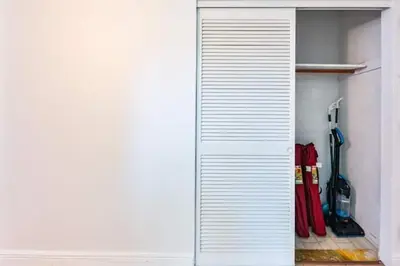 a closet with a white door and some tools at Center of Joy in Sunny Isles Beach