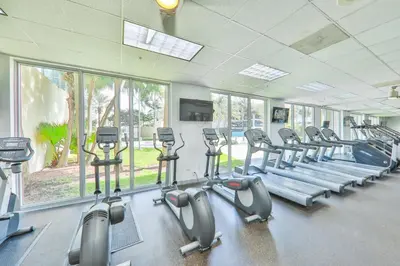 a gym with rows of treadmills and elliptical machines at 2bed free parking ocean view STR - 02584 in Sunny Isles Beach