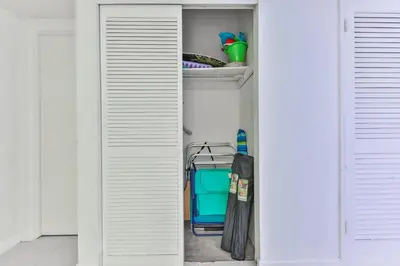 an open closet with a blue cooler and an umbrella at The Elevated Above STR-02687 in Sunny Isles Beach