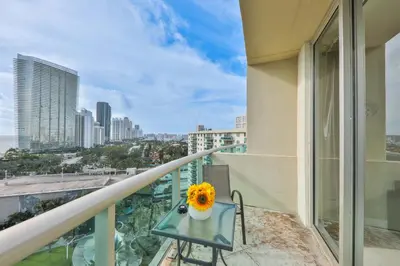 a balcony with a table and a vase of flowers at Ocean view Penthouse - Royal stay in Sunny Isles Beach