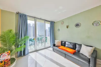 a living room with a couch and a large window at Ocean view Penthouse - Royal stay in Sunny Isles Beach