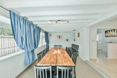 a dining room with a wooden table and chairs at Quiet family vacation minutes from Airport in Fort Lauderdale