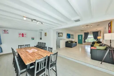 a dining room and living room with a table and chairs at Quiet family vacation minutes from Airport in Fort Lauderdale