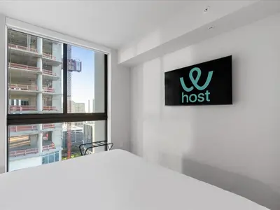 a bedroom with a bed and a window at Condo Steps from Bayfront & the Kaseya Center in Miami
